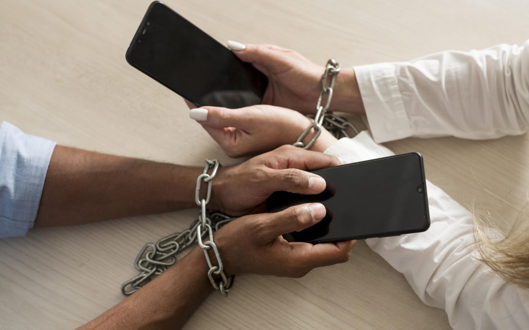 Two individuals, chained together, each holding a smartphone, symbolizing the impact of social media on relationships and mental health.